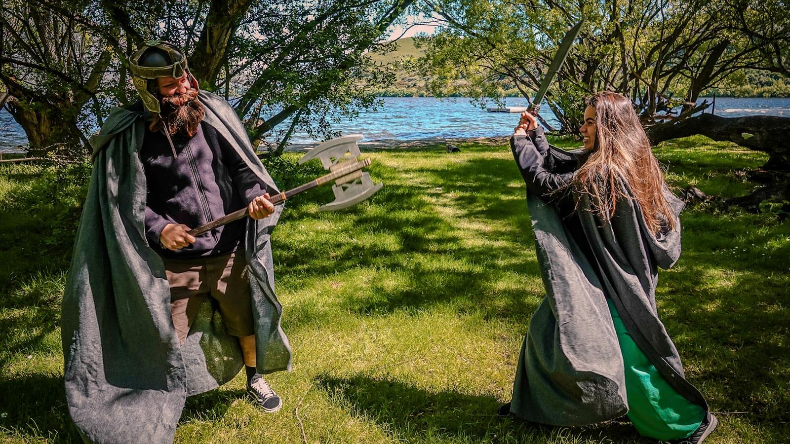 Couple dressed in Lord of the Rings costumes re-enacting a battle scene